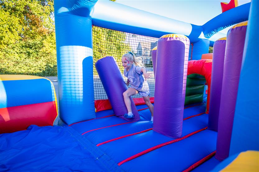 A girl runs through an inflatable obstacle course